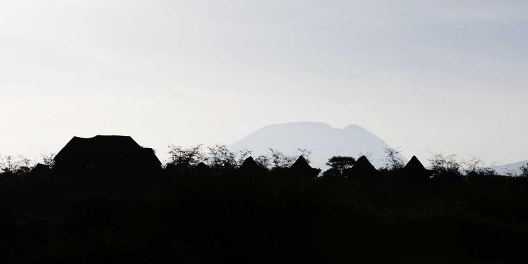 Silouette of the camp and Kilimanjaro behind