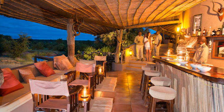 Enjoy a pre-dinner drink at the Mashatu Main Camp Bar.