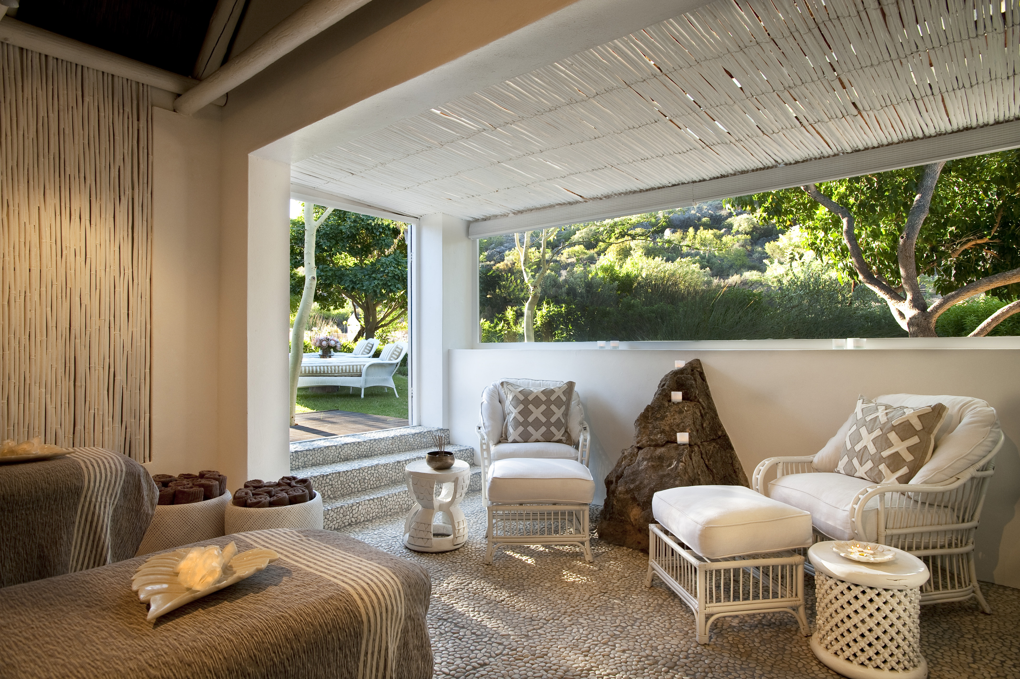 A partially open dual treatment room with views of the spa gardens
