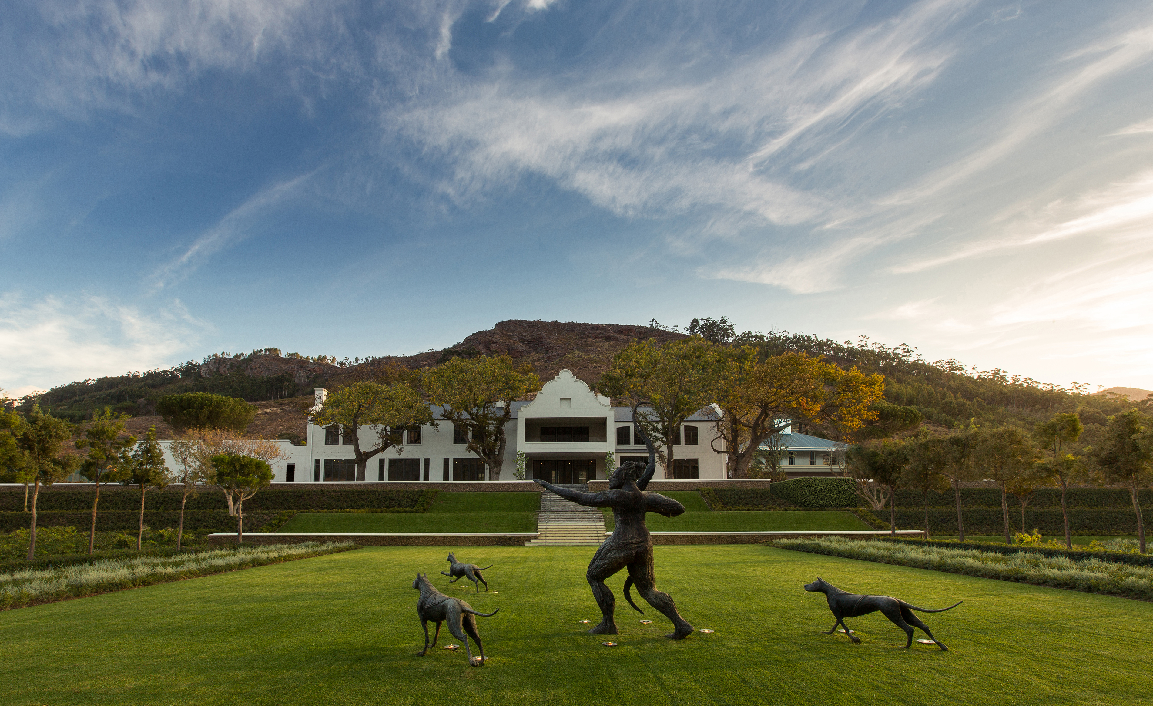 Manor House at Leeu Estate with Artemis and her three dogs in the foreground