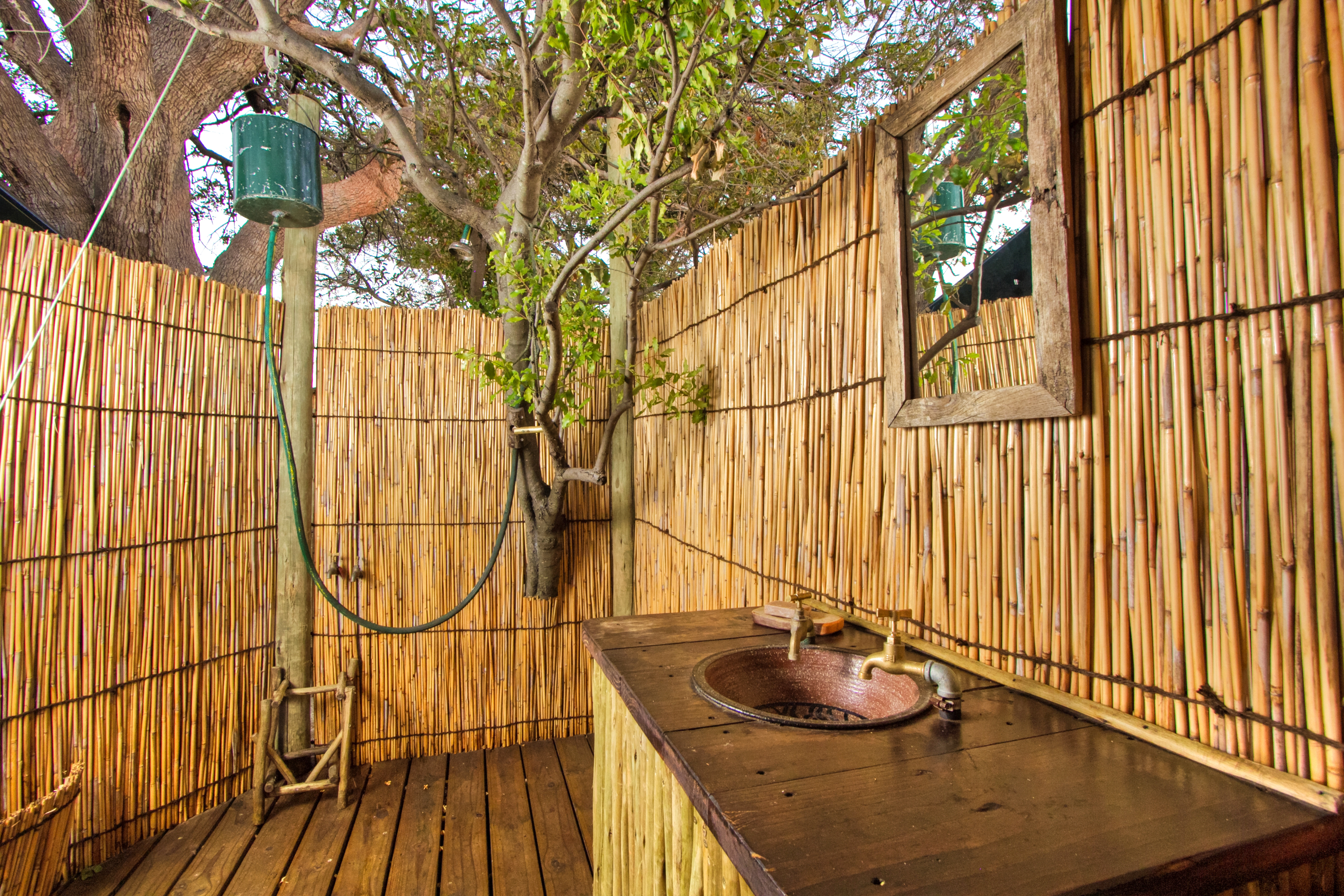 Oper air bathroom with bucket showers