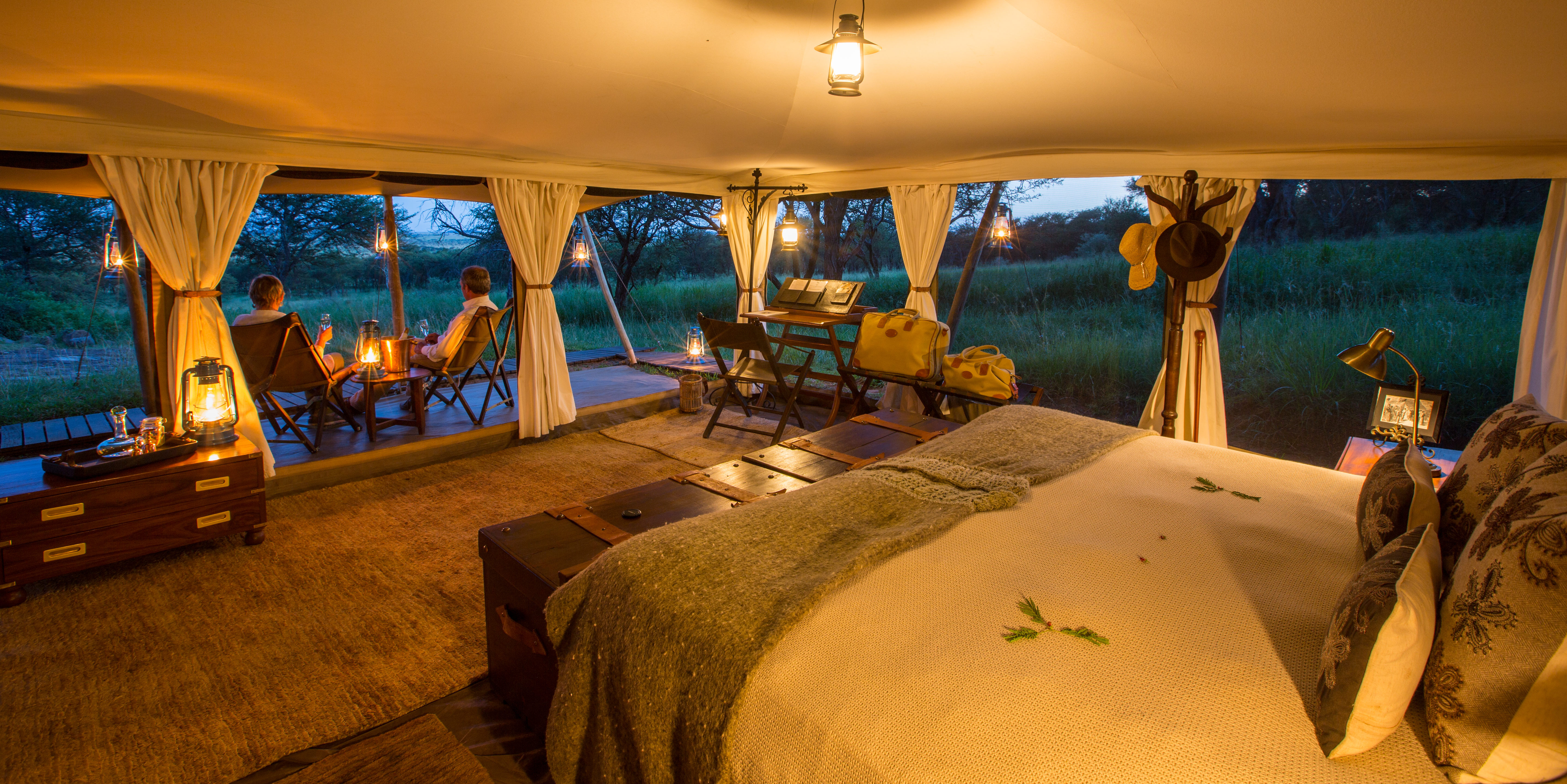Large tents decorated in traditional safari-style furniture 