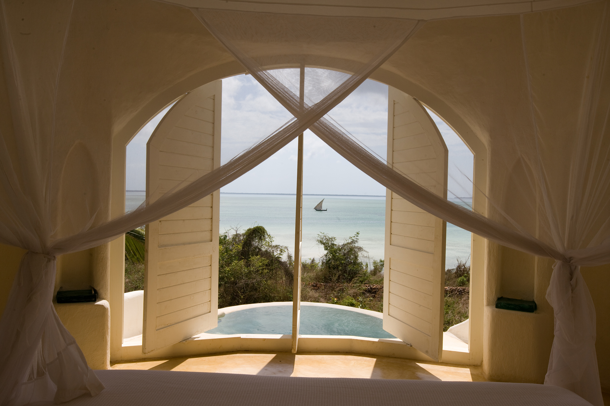 Shuttered windows of a pavilion with views to the azure Indian Ocean