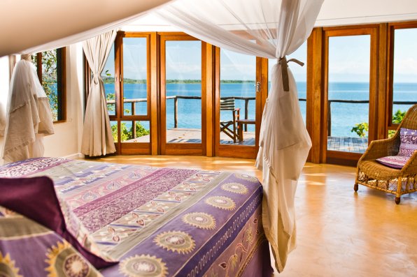 Each villa has a spacious bedroom which extends onto a balcony with a view.
