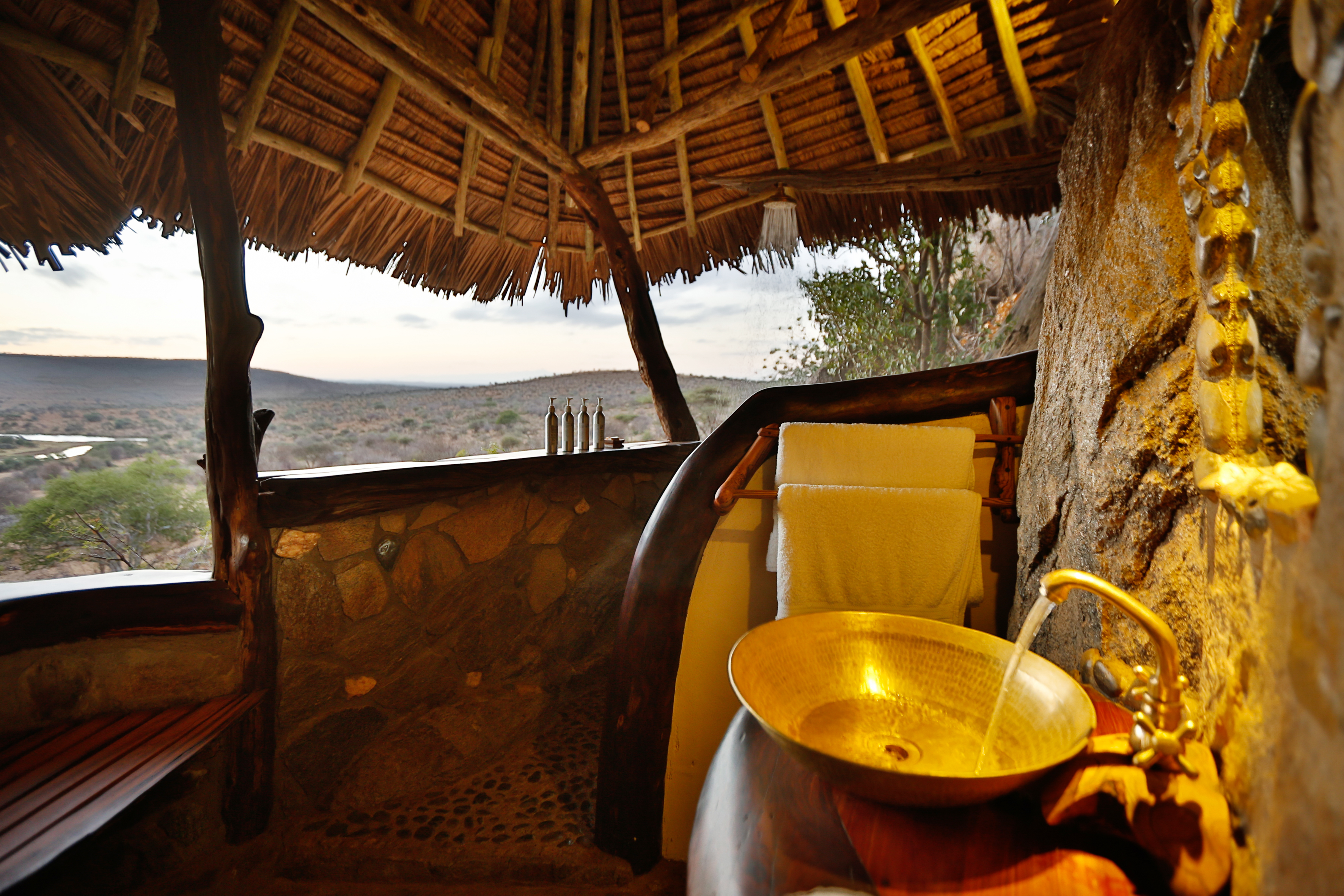 Bathroom designed with all-natural materials and affording views over the Loisaba landscape