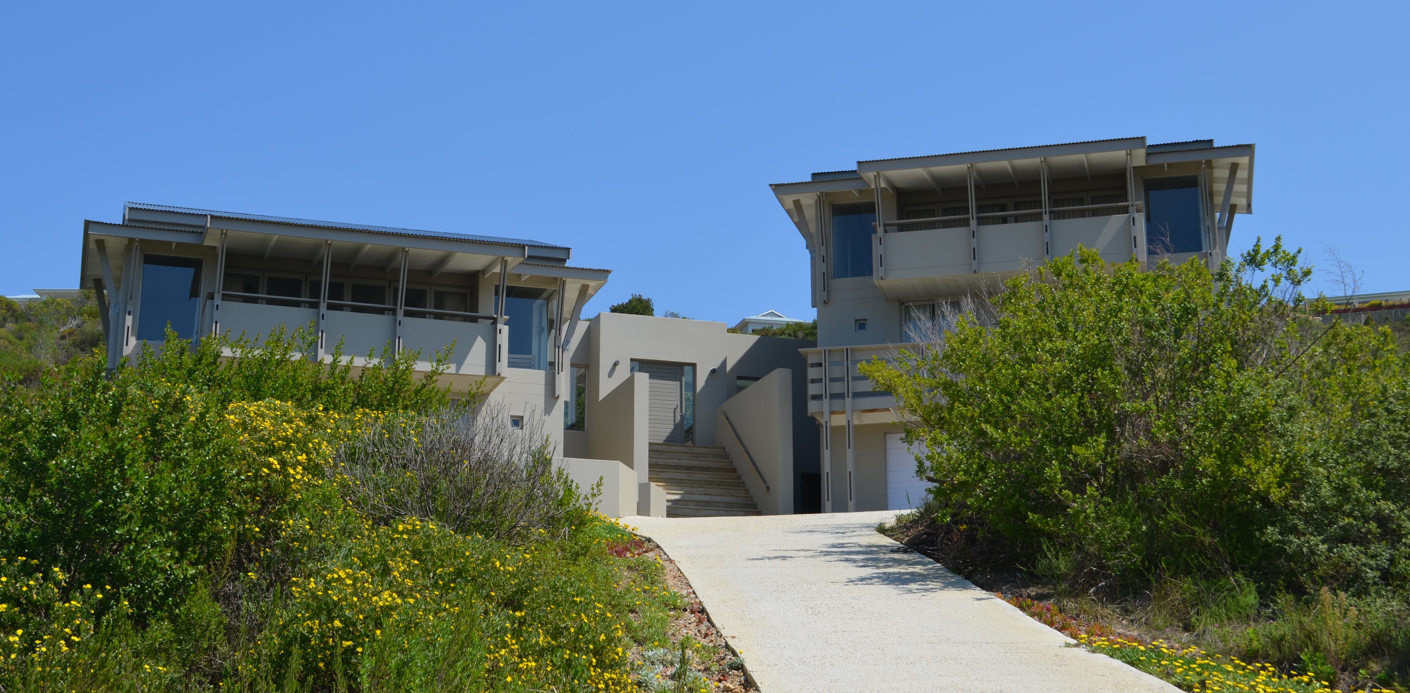 Two identical units interlinked with deck and pool area