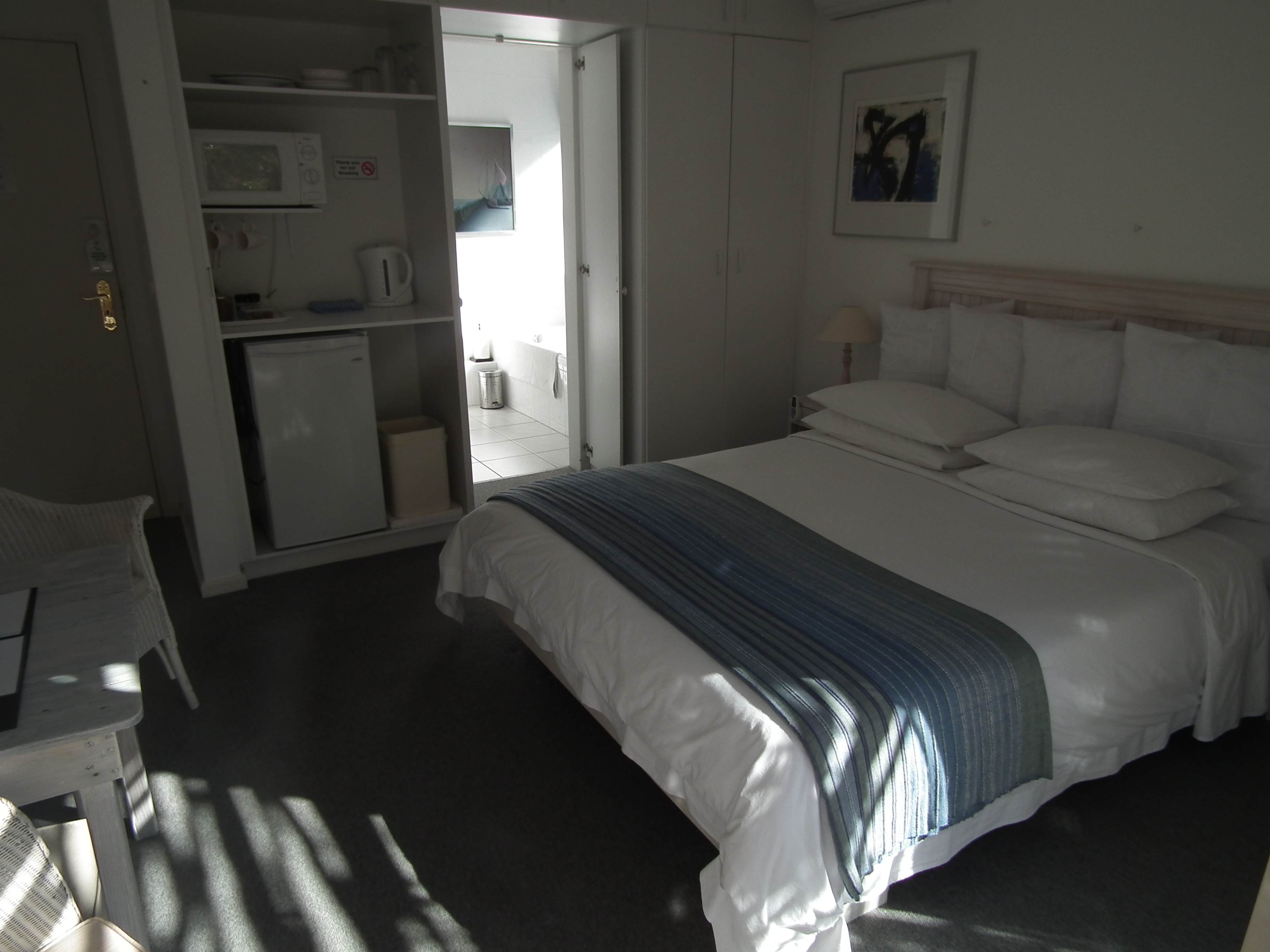 King size bed, full en-suite bathroom (bath &#38; shower), private wooden deck with direct access to solar heated pool, unobstructed view of mountain and Fernkloof Nature Reserve