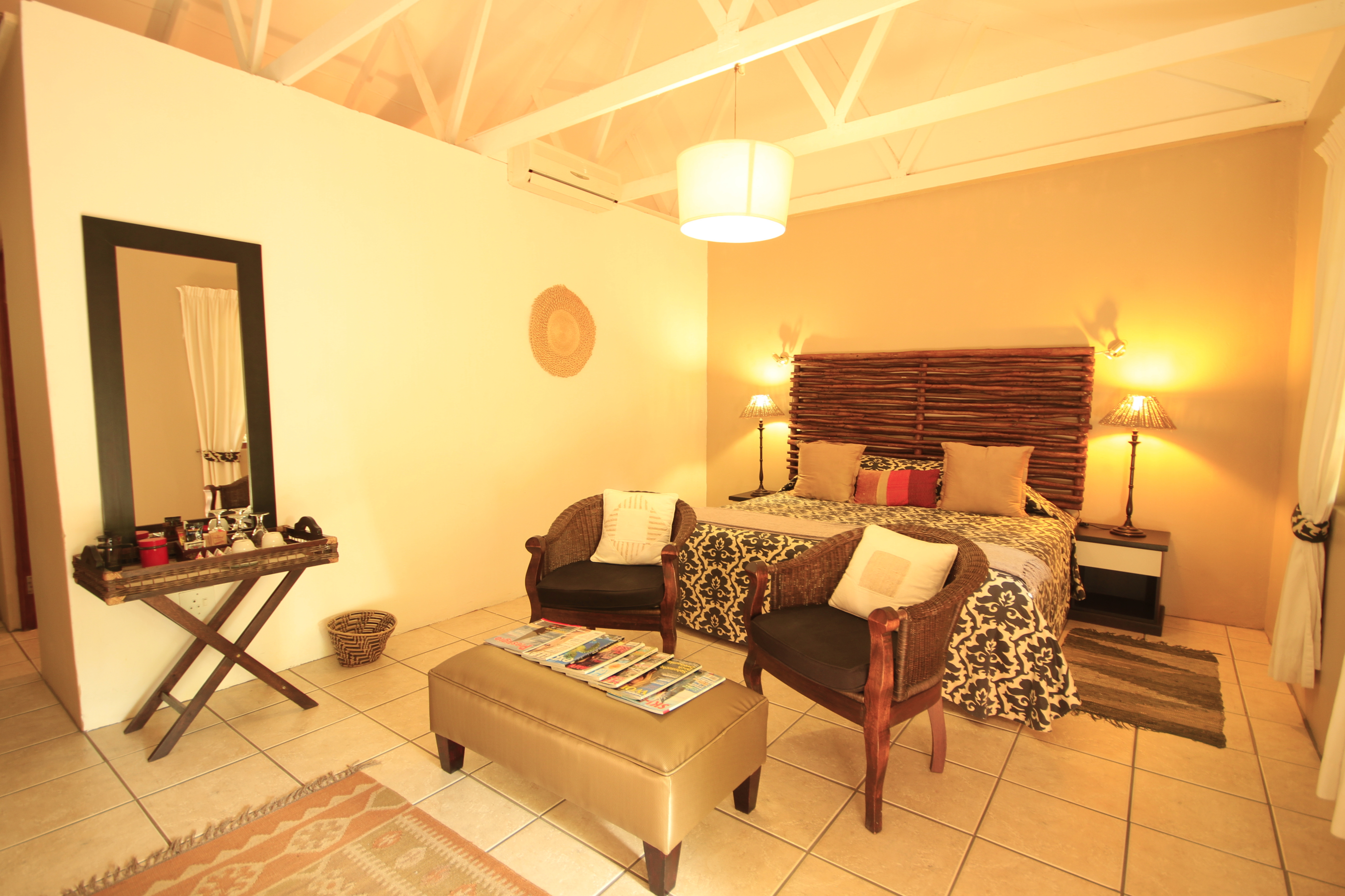 Standard room with private patio, air conditioned, complimentary tea and coffee tray, flat screen television, wall safe,  bar fridge