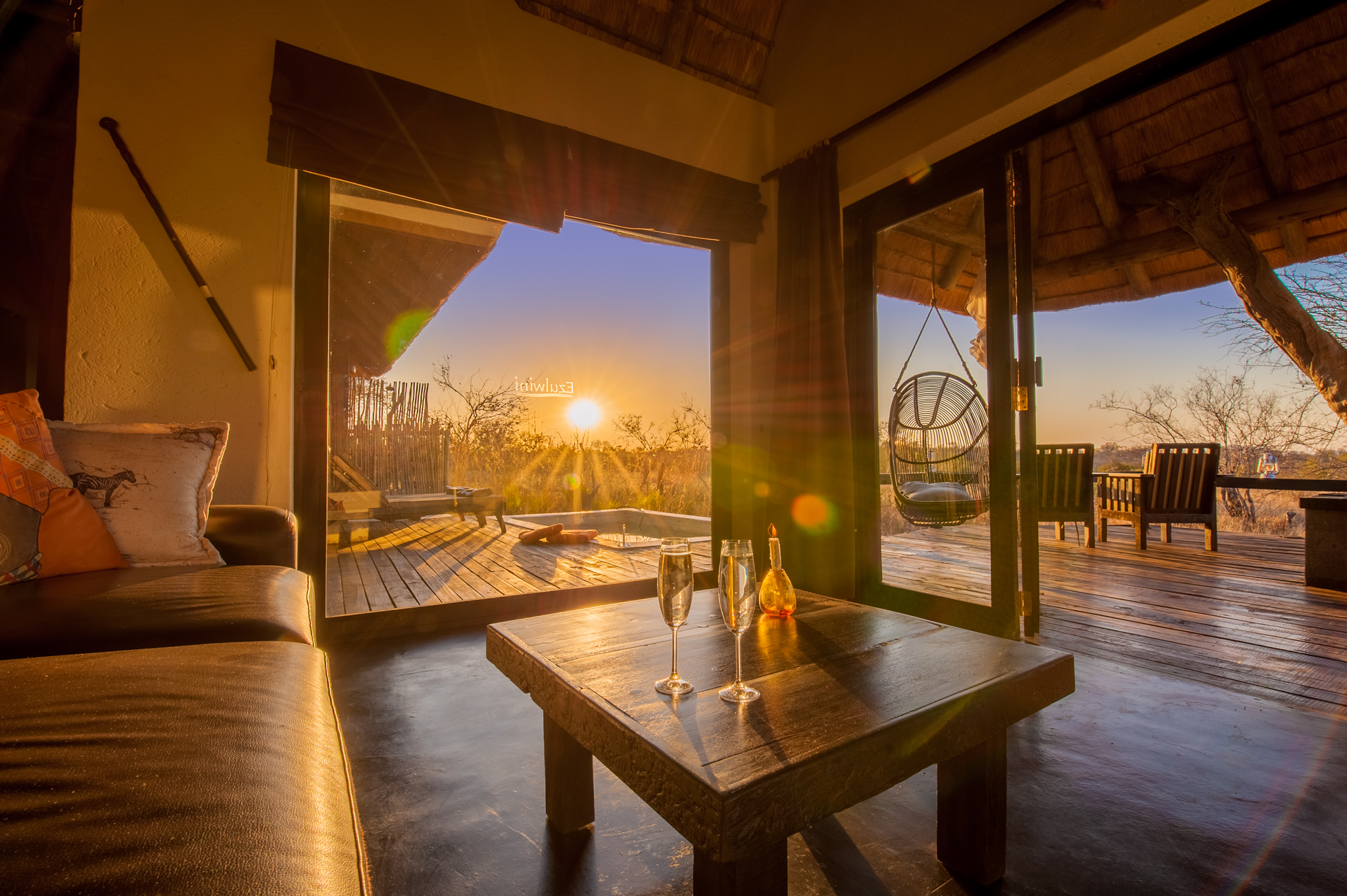 Sunset seen from within a luxury suite lounge at Billy's Lodge