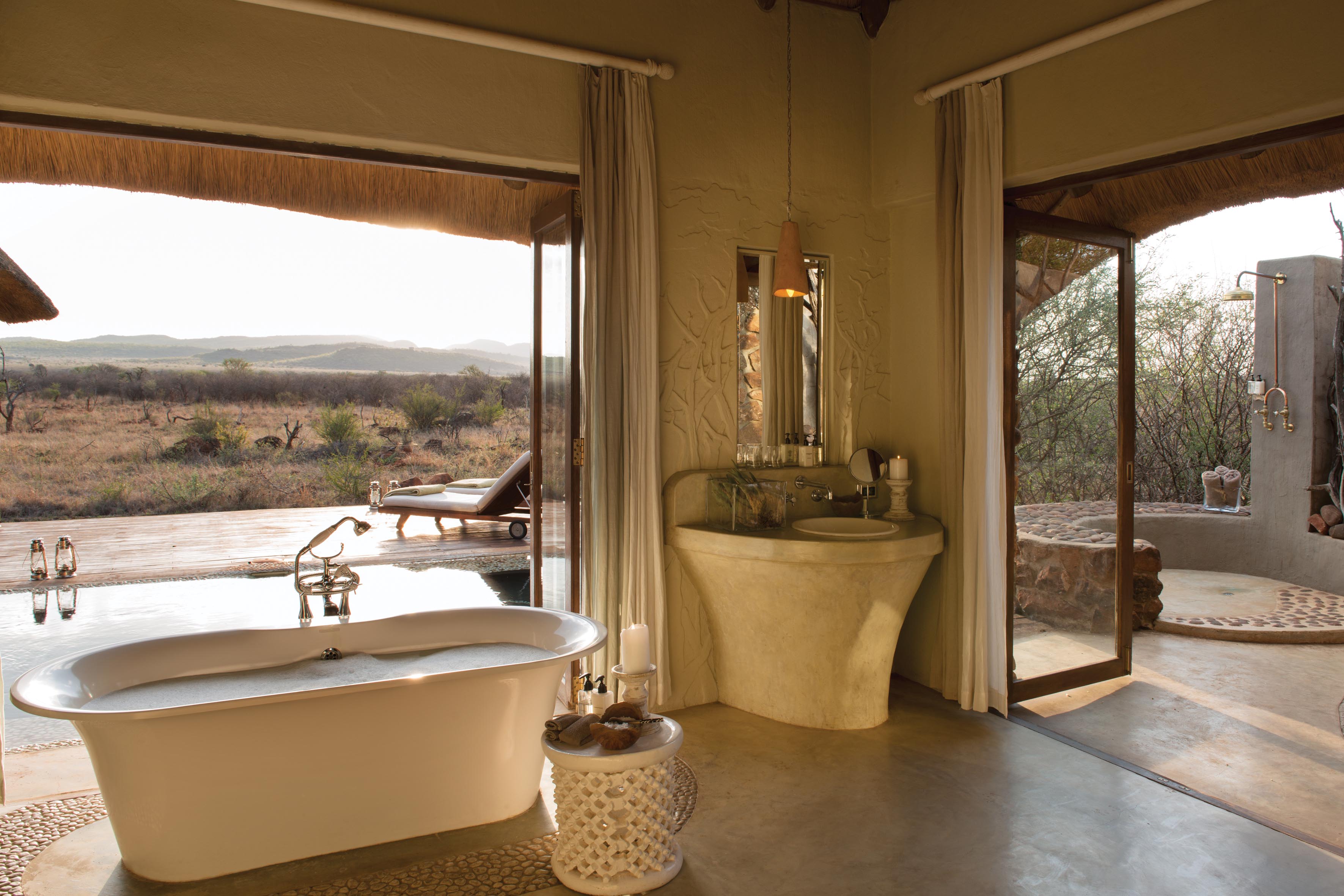 Bathrooms boast indoor and outdoor showers and a bath with amazing views of the endless Bushveld