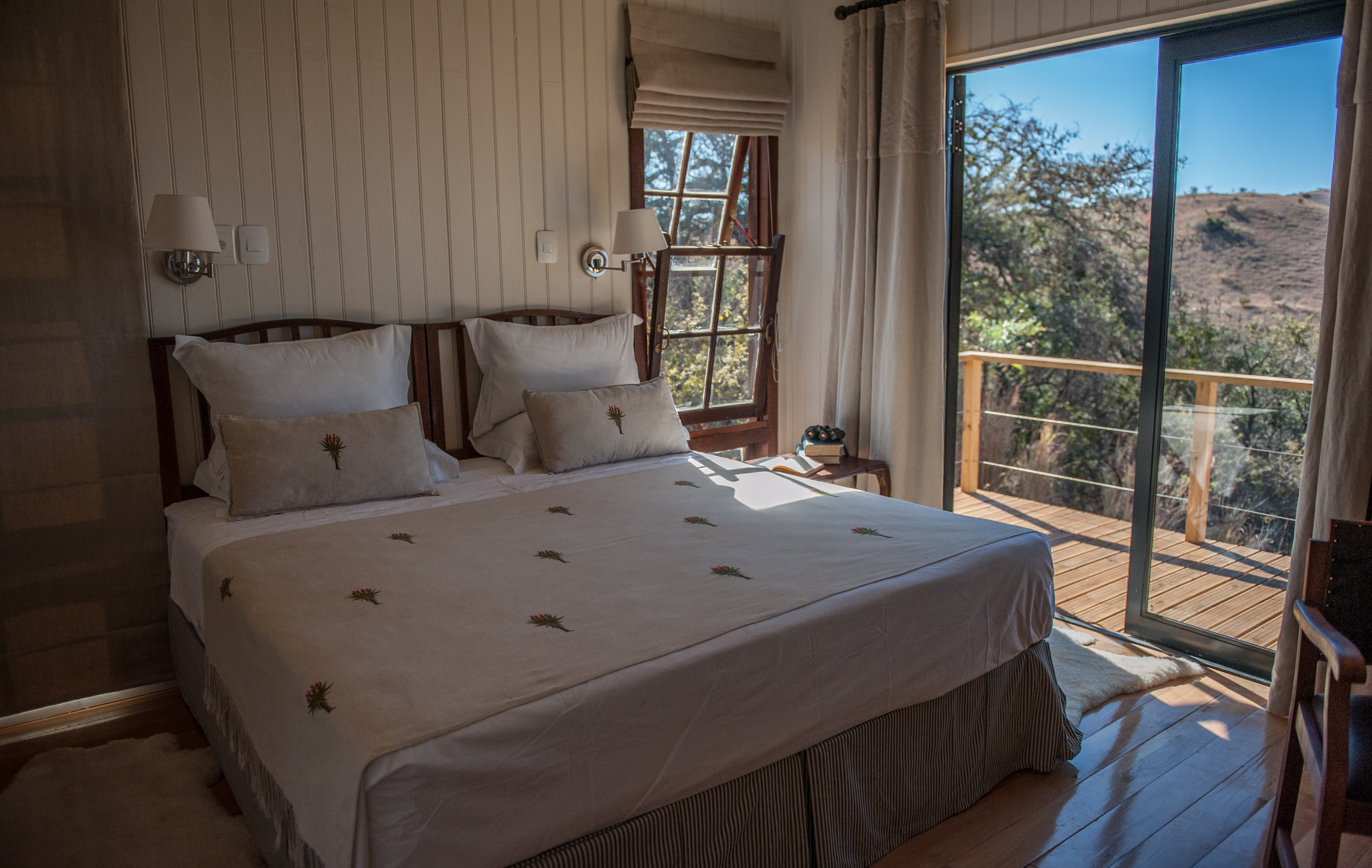 Churchills Bedrooms with open glass doors leading onto deck overlooking Spioenkop Game Reserve