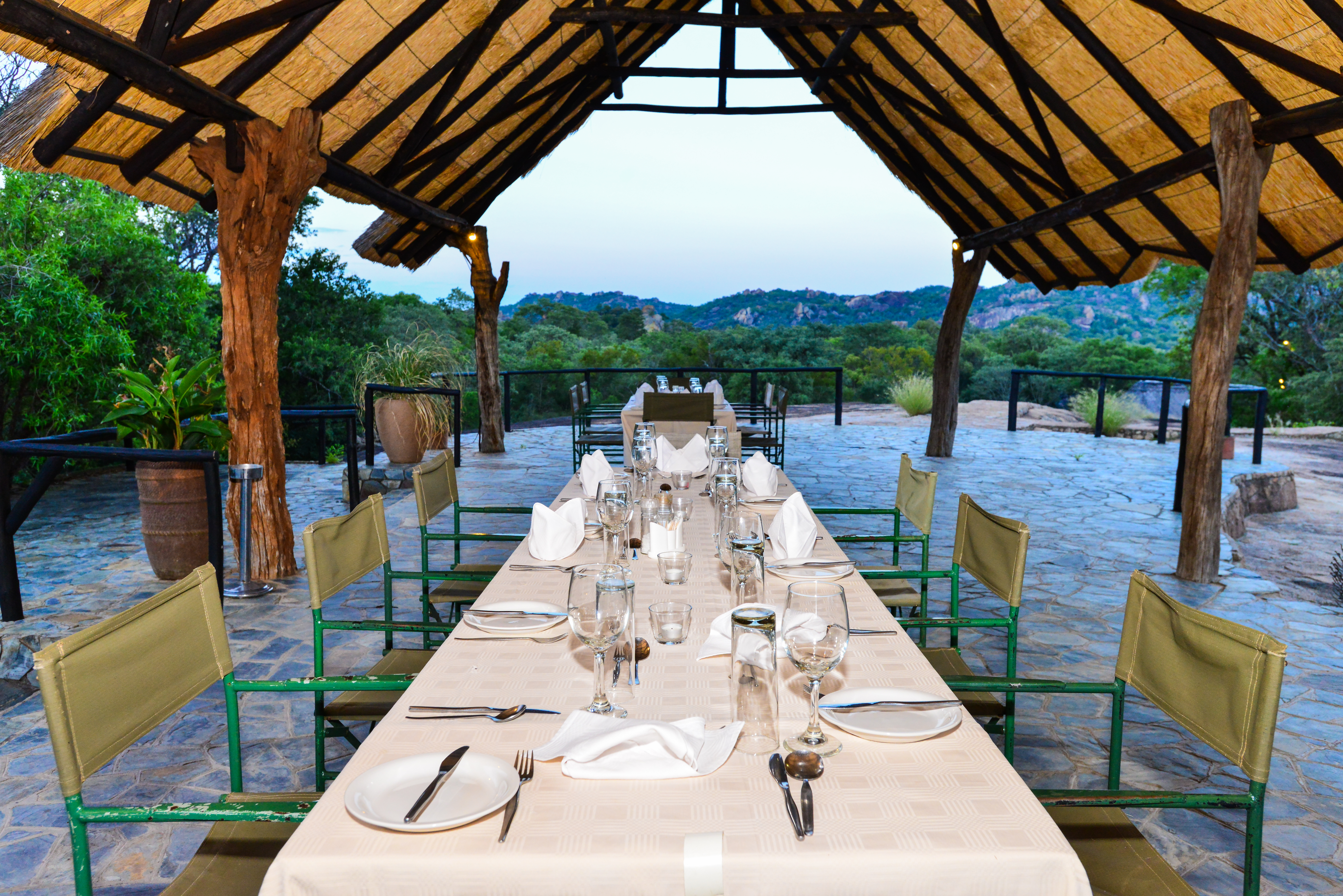 Meals are served under a thatch dining area.