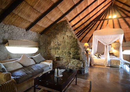 Room 3 is a Standard Family room on the ground level of Camp Amalinda and still incorporates some of the granite structures. There are no stairs to Room 3 and it is an open plan bedroom, lounge & bathroom area with 2 double beds. The ensuite bathroom consists of a shower & bath, toilet and single rock basin. If required, there is space for an extra single bed in the family room. Amenities include tea & coffee stations, fan, mosquito nets, mosquito coils, open wardrobe, private outside veranda, hair dryers & electric blankets.