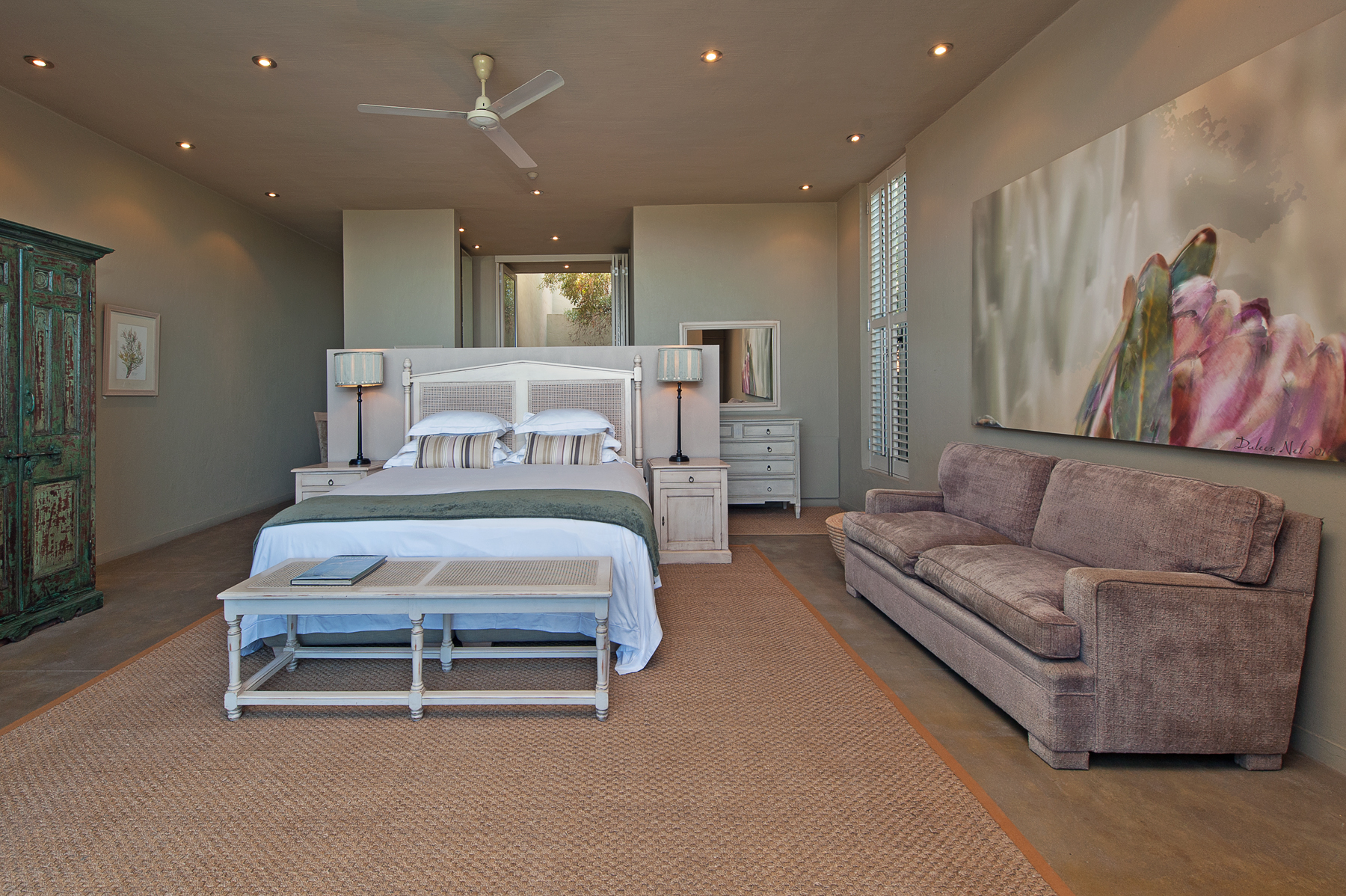 Protea painting with king bed and double sleeper couch in Fynbos executive suite