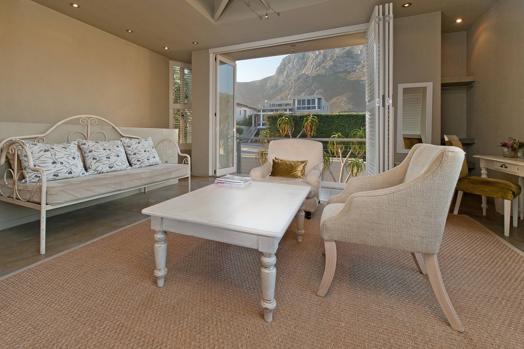Seating area, single day bed and mountain facing balcony