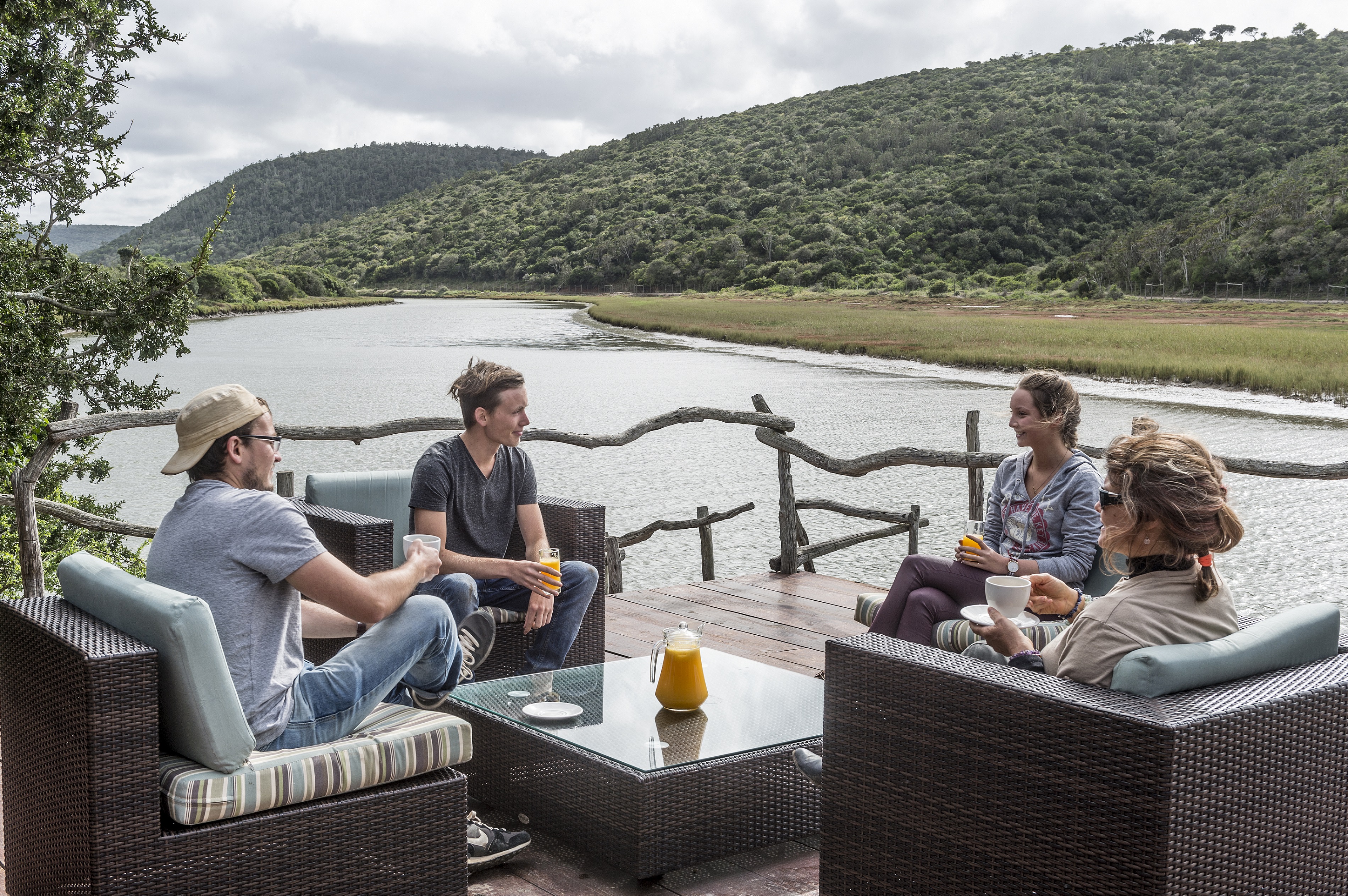 Guests enjoying drinks on the deck overlooking the Bushman's river