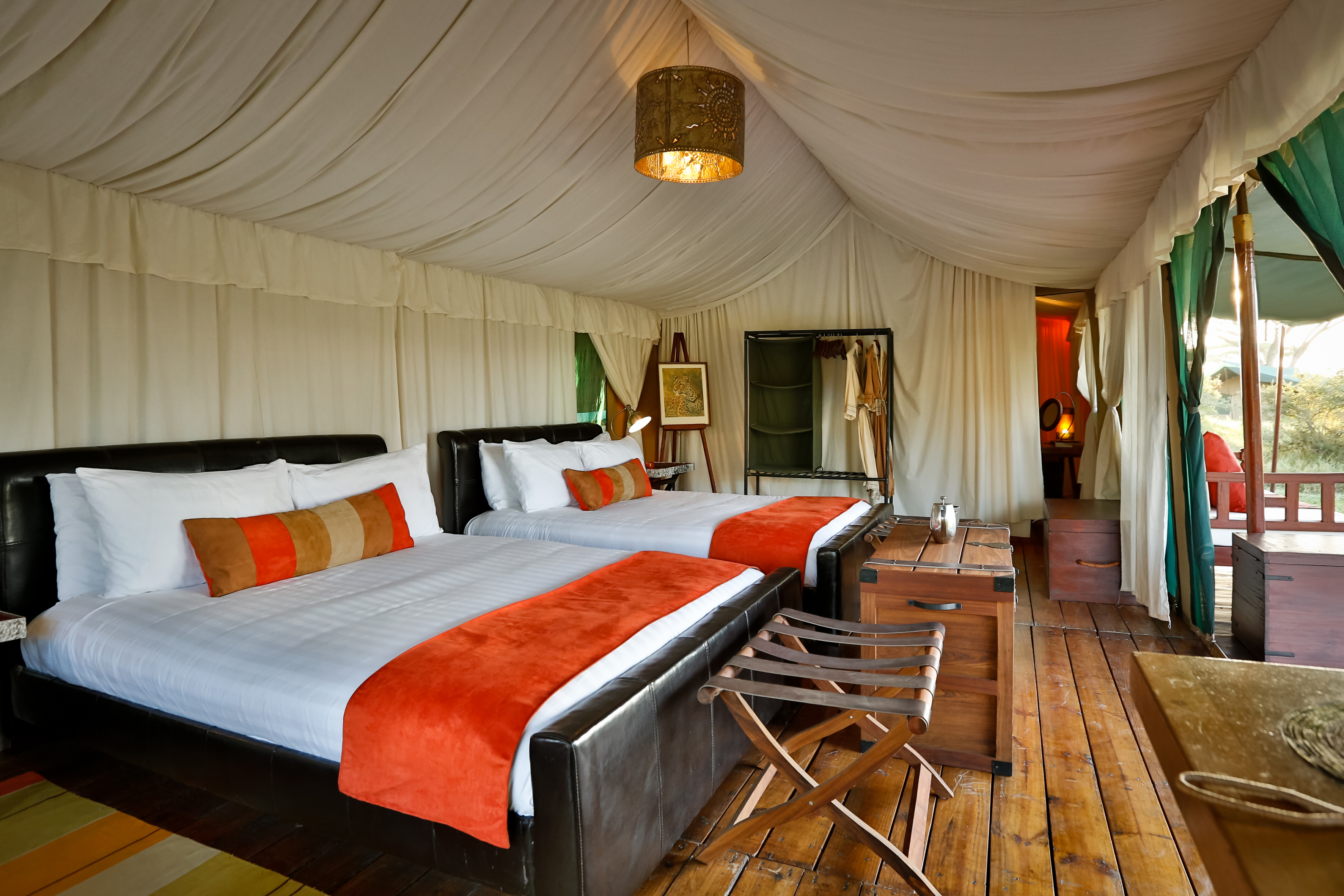 The tents all enjoy queen size twin beds.  All are ensuite with flushing toilets and hot showers.  Power is provided by an inverter and available 24 hrs a day.  Very spacious with lots of room to relax and unwind