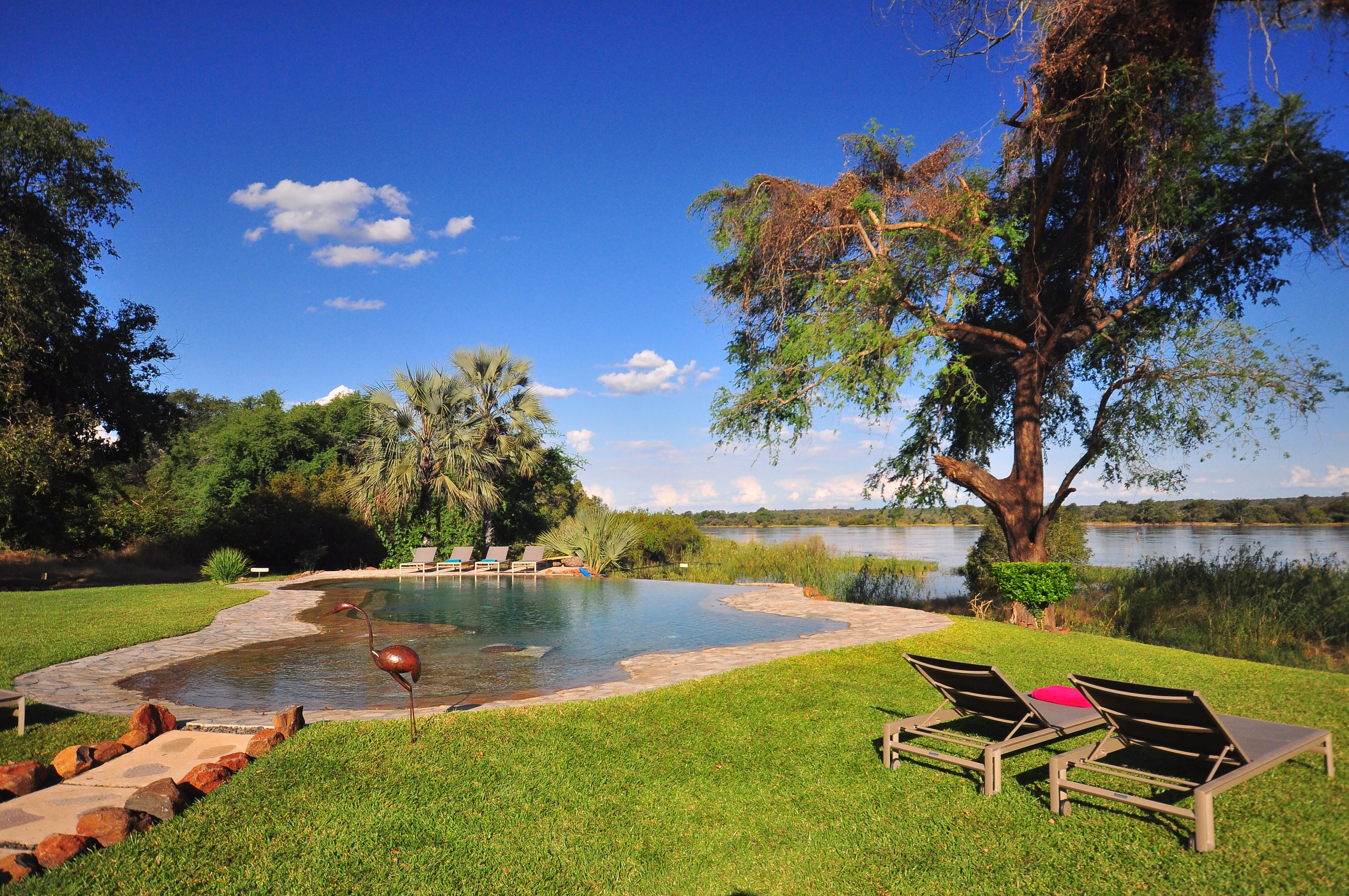 Vast open lawns surround the infinity swimming pool