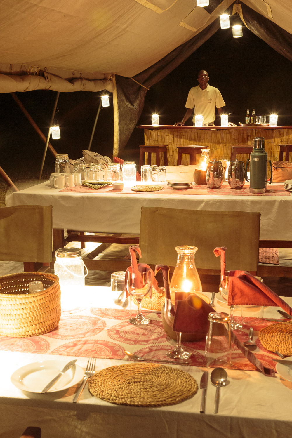 Atmospheric night-time interior of Nkonzi Camp's Swahili-style dining tent