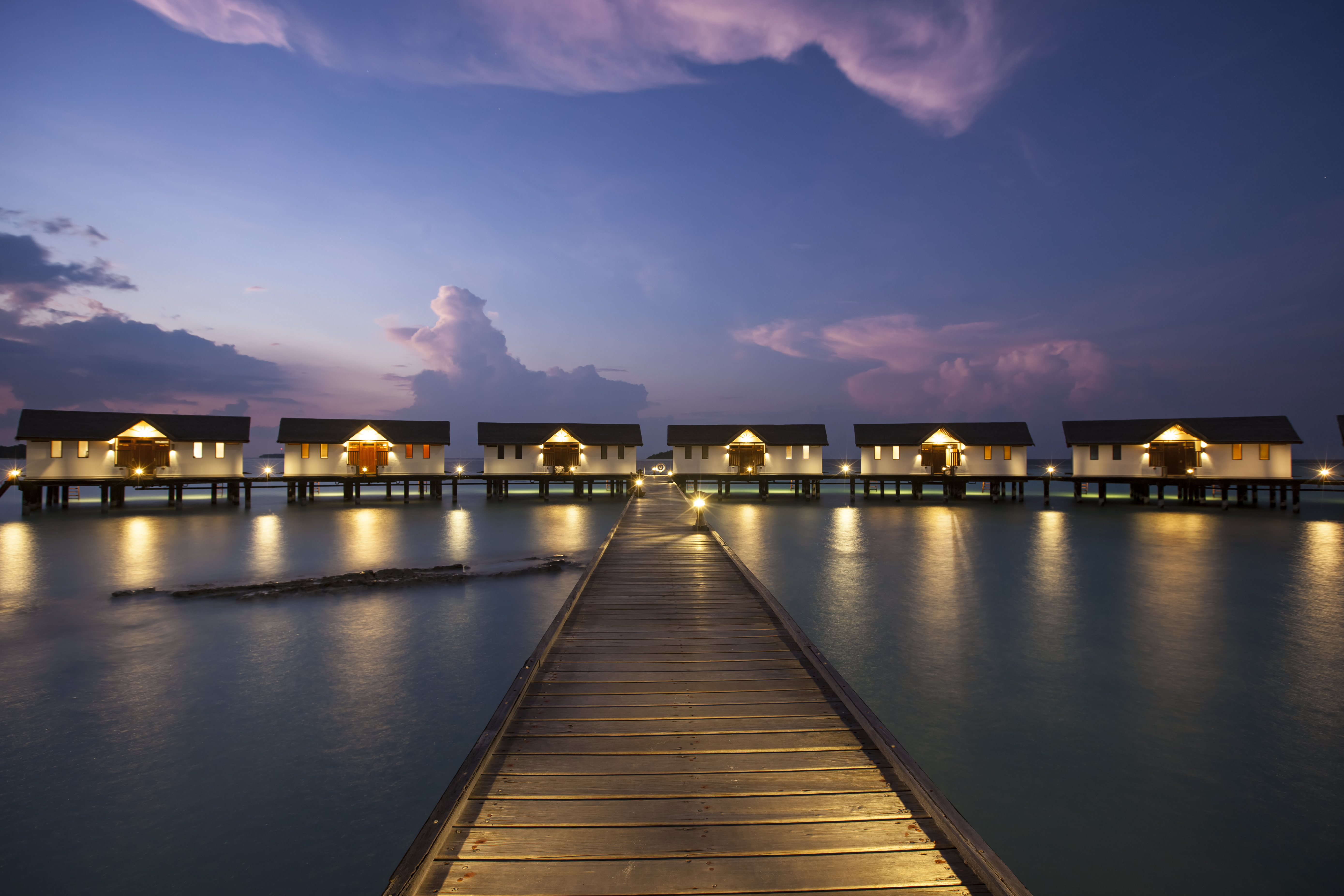 View of water villas during sunset