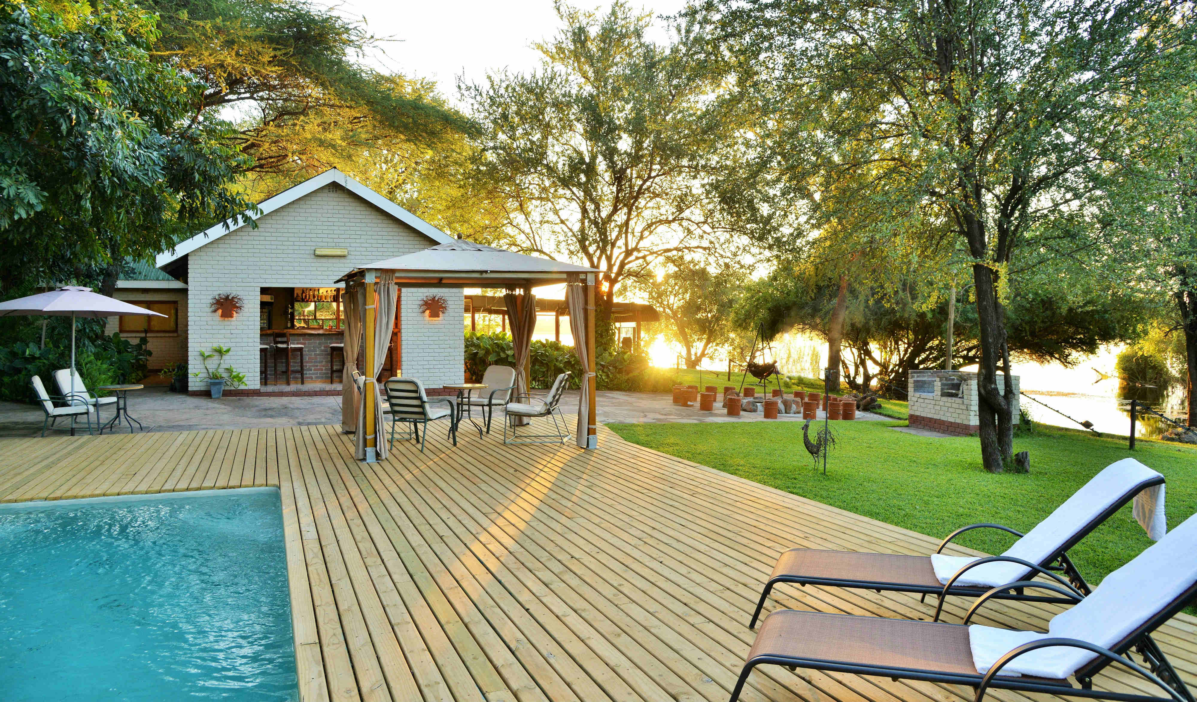 Public area at River View Lodge, including swimming pool and bar overlooking the Chobe River.